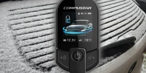 The Compustar T13 Remote Starter hovering in the air in front of a car with snow all over it